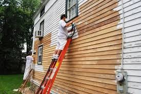 Factors affecting the cost of painting a house exterior, including labor, materials, and home size